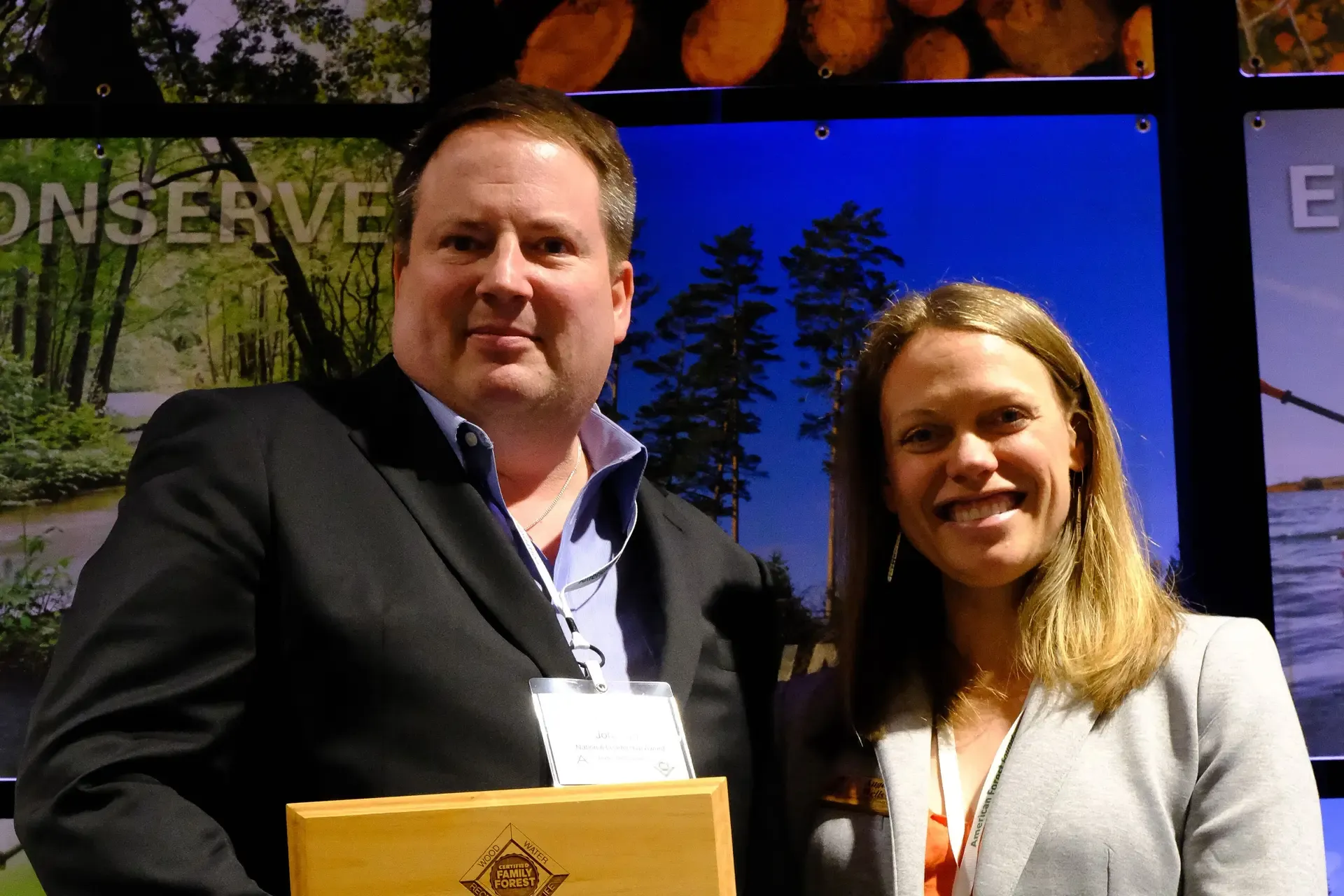 Jennifer Lambert Johnson’s husband accepting the National Leadership Award on her behalf at the National Leadership Conference